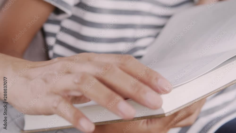 Close-up hand of Mother and daughter sitting open the book reading in the park, Education concept Close-up hand of Mother and daughter sitting open the book reading in the park, Education concept