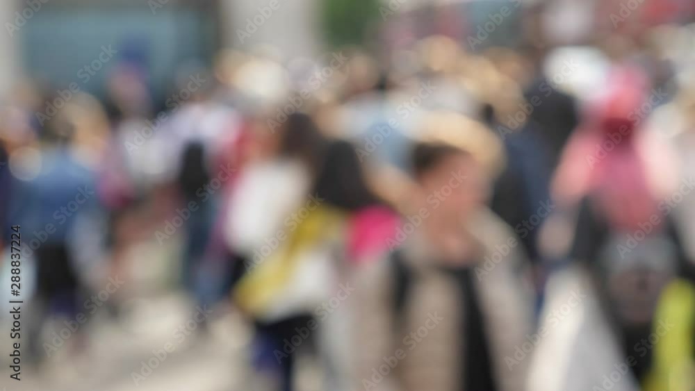 Defocused blurred silhouettes of large group of pedestrians friends crossing street on Oxford Circus interchange between Bakerloo Central Victoria Defocused blurred silhouettes of large group of pedestrians friends crossing street on Oxford Circus interchange between Bakerloo Central Victoria