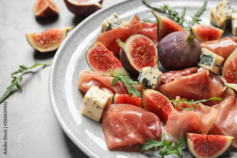 Plate with figs, prosciutto and cheese, closeup