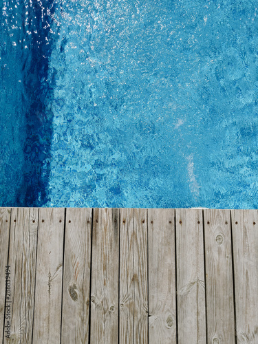wooden platform on swimming pool background. top view. Procurement, a template for design with place for text. Old boards and a lake copy space.