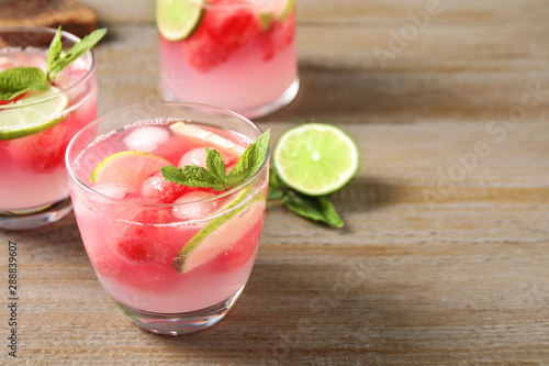 Tasty refreshing watermelon drink on wooden table. Space for text