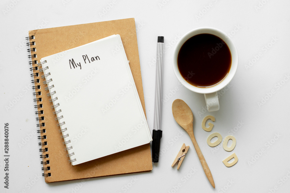 Notebook with My Plan text on top of white notebook with coffee on office desk .Life planning concept. Notebook with My Plan text on top of white notebook with coffee on office desk .Life planning concept.