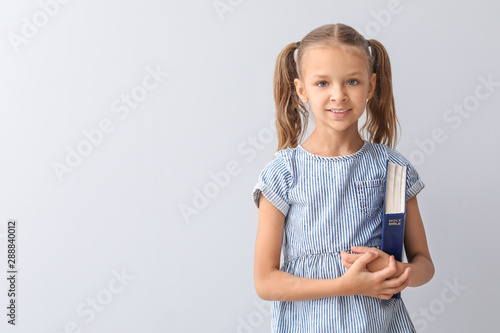 Cute little girl with Bible...