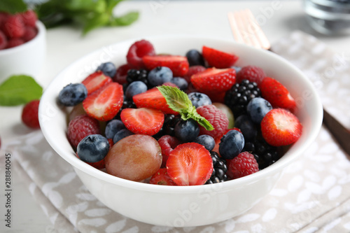 Fresh tasty fruit salad on table  closeup