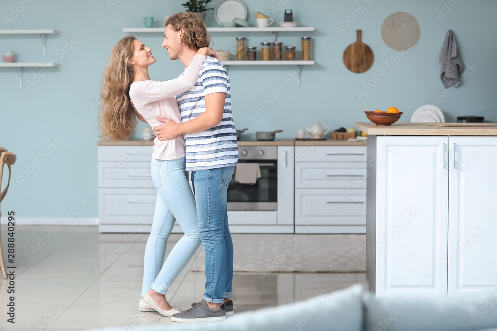 Happy young couple dancing in kitchen Happy young couple dancing in kitchen
