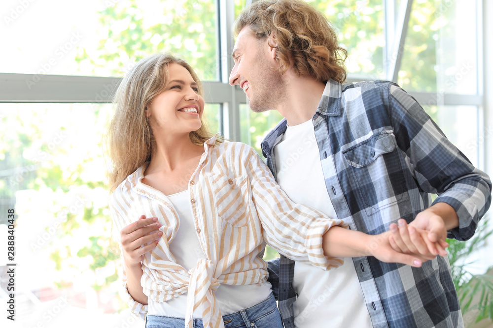 Fototapeta premium Happy young couple dancing at home
