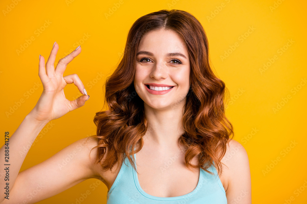 Close up photo of charming pretty sweet nice girlfriend wearing teal singlet showing you ok sign while isolated over bright yellow color background Close up photo of charming pretty sweet nice girlfriend wearing teal singlet showing you ok sign while isolated over bright yellow color background