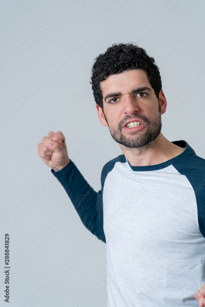 Handsome angry young man with furious face looking disgusted. Human expressions and emotions Handsome angry young man with furious face looking disgusted. Human expressions and emotions