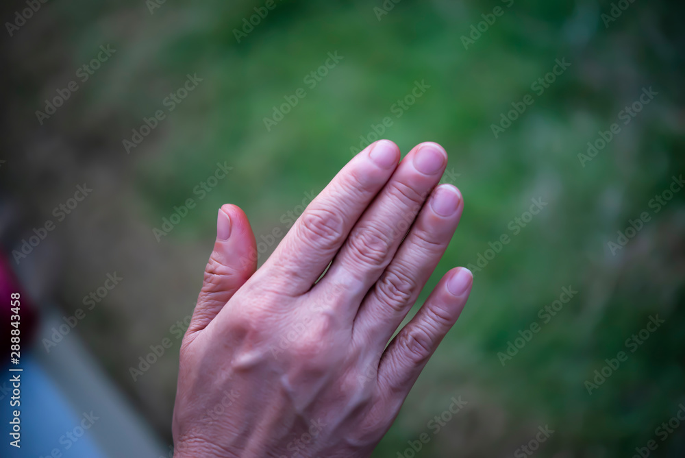 The hand that is bent and upside down makes it visible only on the back of the hand. The hand that is bent and upside down makes it visible only on the back of the hand.