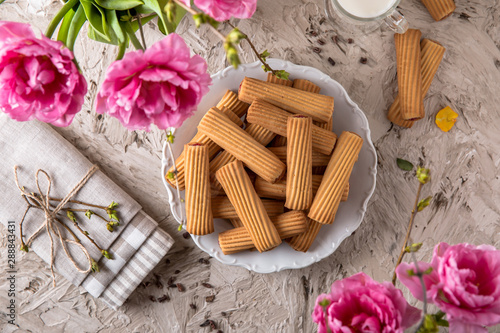 Fototapeta Naklejka Na Ścianę i Meble -  Biscuit sticks with fruit filling. Crispy and crumbly delicious cookies with natural ingredients: flour, nuts, seeds, pieces of chocolate, cocoa, fruit jams. Spring Flower Still Life