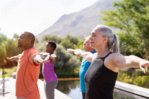 Mature group of people doing breathing exercise