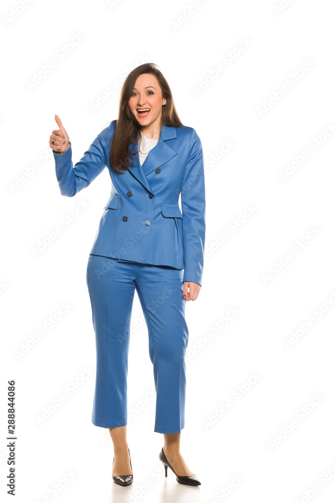 Happy businesswoman standing on white background and showing thumbs up Happy businesswoman standing on white background and showing thumbs up