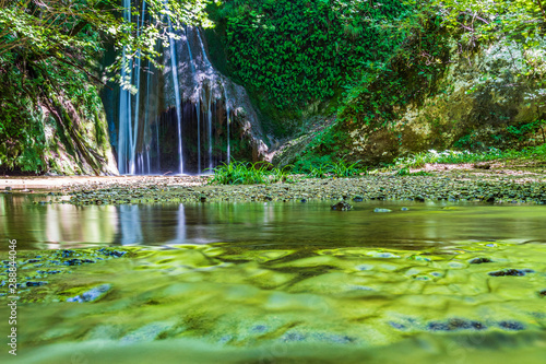 Waterfall surrounded by greenery. Acquacaduta. Friuli  Italy