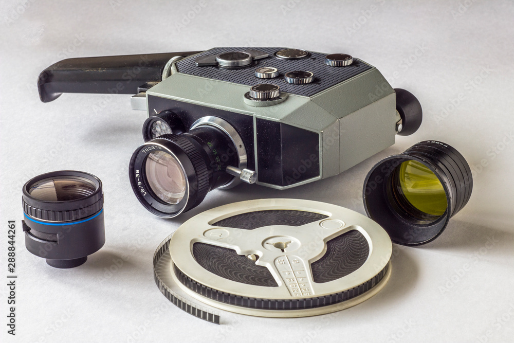 film reel and old color lenses on the background of a vintage mechanical  video camera Stock Photo