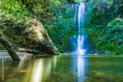 Waterfall surrounded by greenery. Acquacaduta. Friuli  Italy