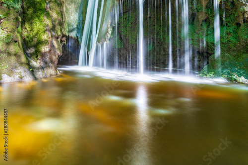 Waterfall surrounded by greenery. Acquacaduta. Friuli  Italy