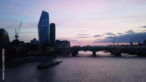 Late afternoon epic looking at London bridge, Lemen river, with the colorful sky, new big building, construction crane. photo