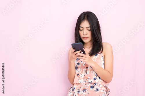 Modern smart technology for business and lifestyle concept. Beautiful young woman working on smartphone. Communication and connection to people online by wireless networking.