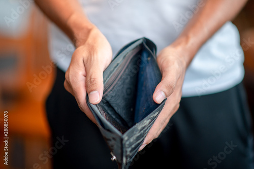 Slika na platnu Business man holding a wallet,hand open an empty wallet, asian man shows her emp