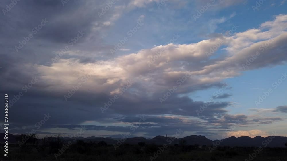 Clouds against a desert mountain landscape at sunset. Timelapse. Clouds against a desert mountain landscape at sunset. Timelapse.