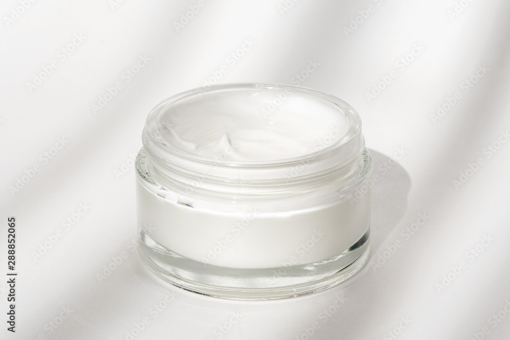 White facial cream jar. Cosmetic moisturizing product. Skin and body care, moisture lotion, wellness therapy mask in glass jar
