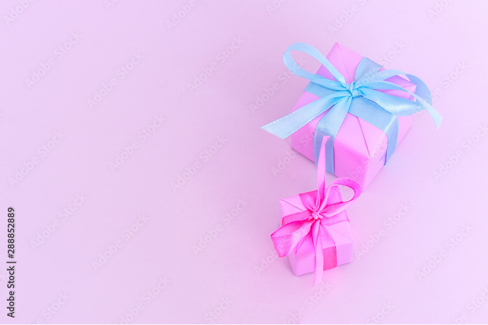 Two pink gift boxes with satin ribbones on pink background, congratulations on Women's Day, mum's day, Valentine's day, happy birthday, Christmas Two pink gift boxes with satin ribbones on pink background, congratulations on Women's Day, mum's day, Valentine's day, happy birthday, Christmas