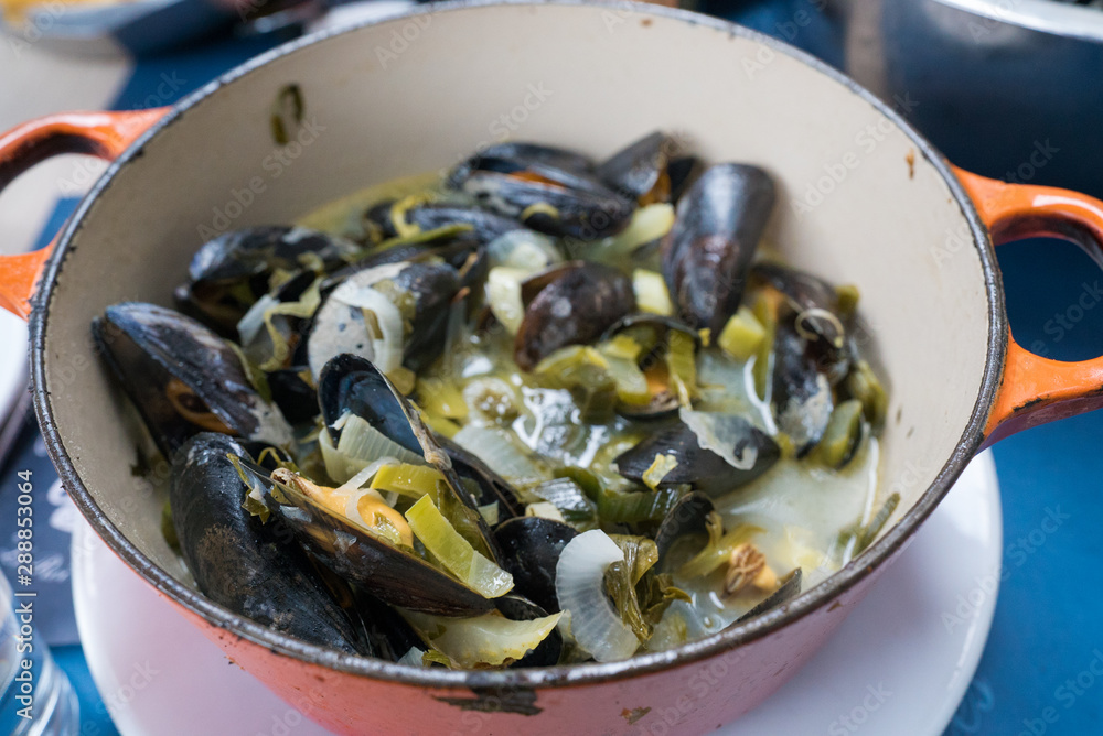close up view of traditional mussel and french fries dish called 