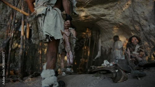 Wallpaper Mural Tribe of Hunter-Gatherers Wearing Animal Skin Live in a Cave. Leader Brings Animal Prey from Hunting, Female Cooks Food on Bonfire, Girl Drawing on Wals Creating Art. Neanderthal Homo Sapiens Family Torontodigital.ca