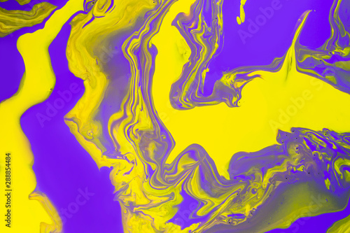 Acrylic Fluid Art. Glowing purple waves and yellow spots. Abstract marble background or texture