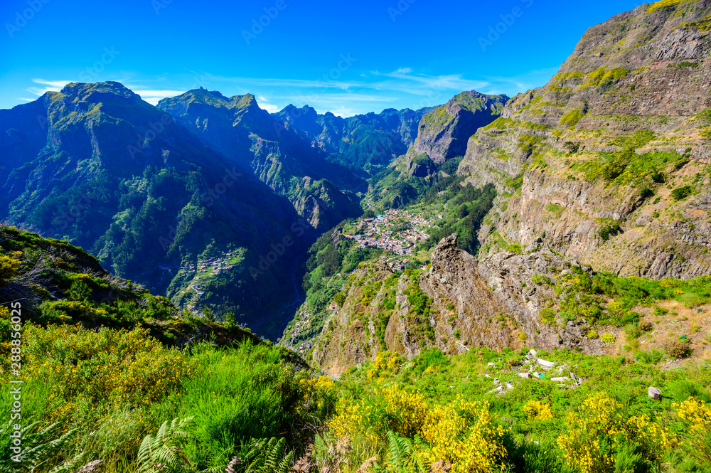 Fototapeta premium View from Eira do Serrado to Curral das Freiras village in the Nuns Valley in beautiful mountain scenery, municipality of Câmara de Lobos, Madeira island, Portugal.