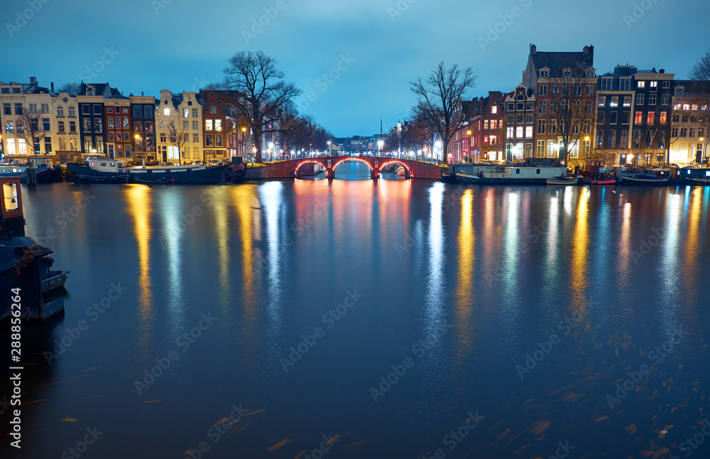 Cityscape at night. Bridge over a canal in Amsterdam, Netherlands.