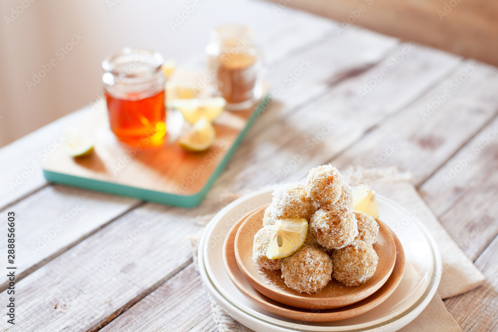 Healthy raw vegan candies with coconut and lemon, concept of tasty vegetarian food Healthy raw vegan candies with coconut and lemon, concept of tasty vegetarian food