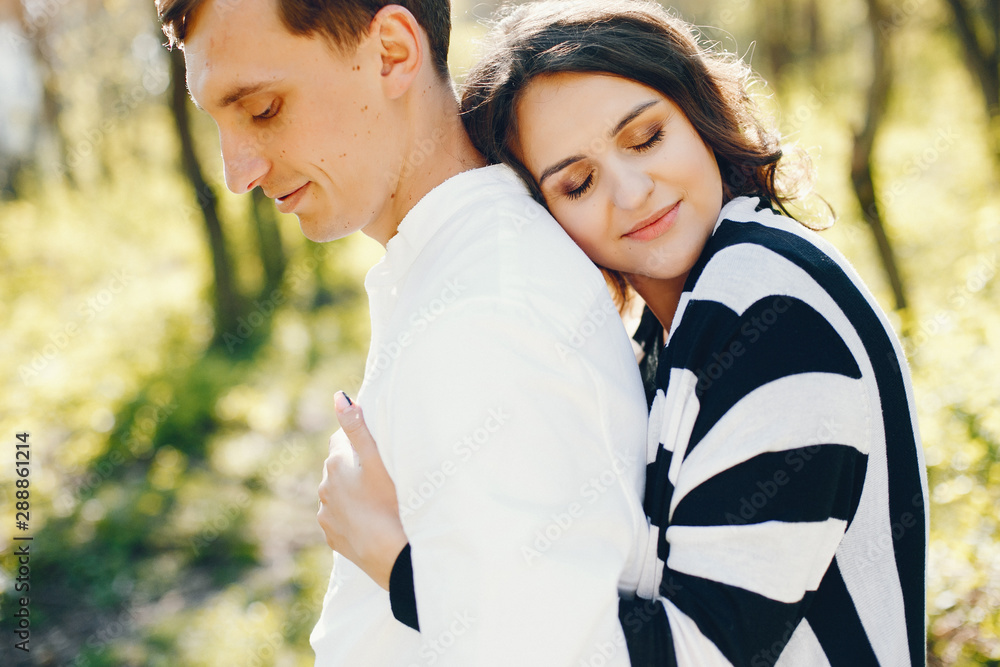 Fototapeta premium bright and happy pregnant woman walking in the park with her husband
