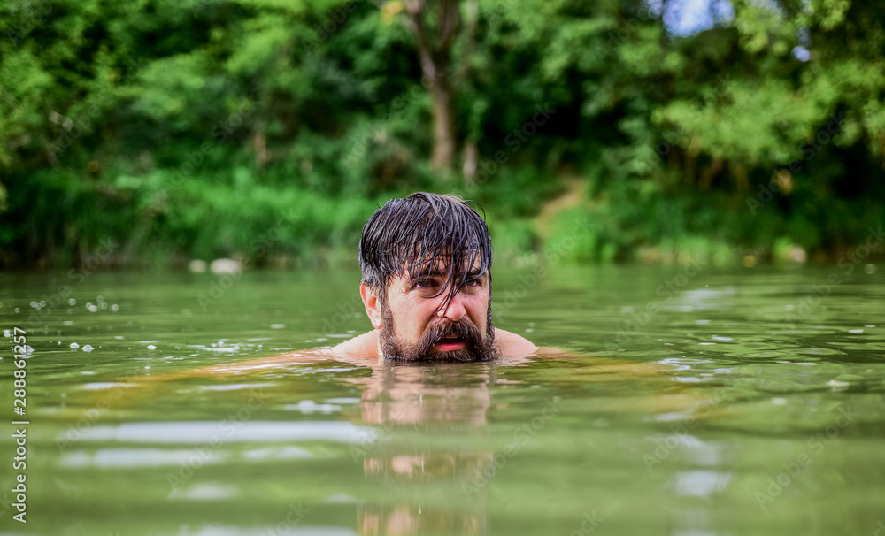 Swimming sport. Swimming skills. Refreshing feeling. Man enjoy swimming in river or lake. Deep dangerous water. Submerge into water. Freshness of wild nature. Summer vacation. Relaxation and rest