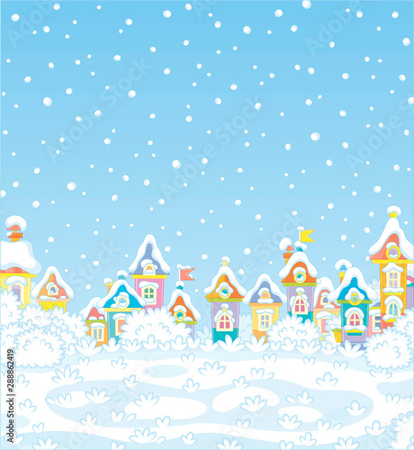 Christmas background with colorful houses of a small toy town on a snowy winter day, vector illustration in a cartoon style