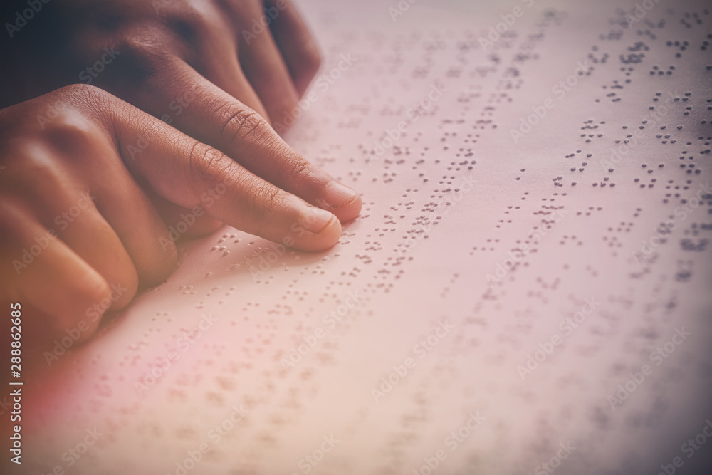 Child using braille to read Child using braille to read