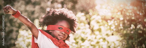 Portrait of boy in red cape and eye mask