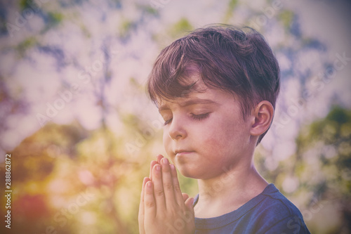 Boy praying with eyes closed
