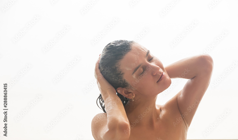 Obraz premium Young woman laying relaxing in bathtub. Woman taking a bath