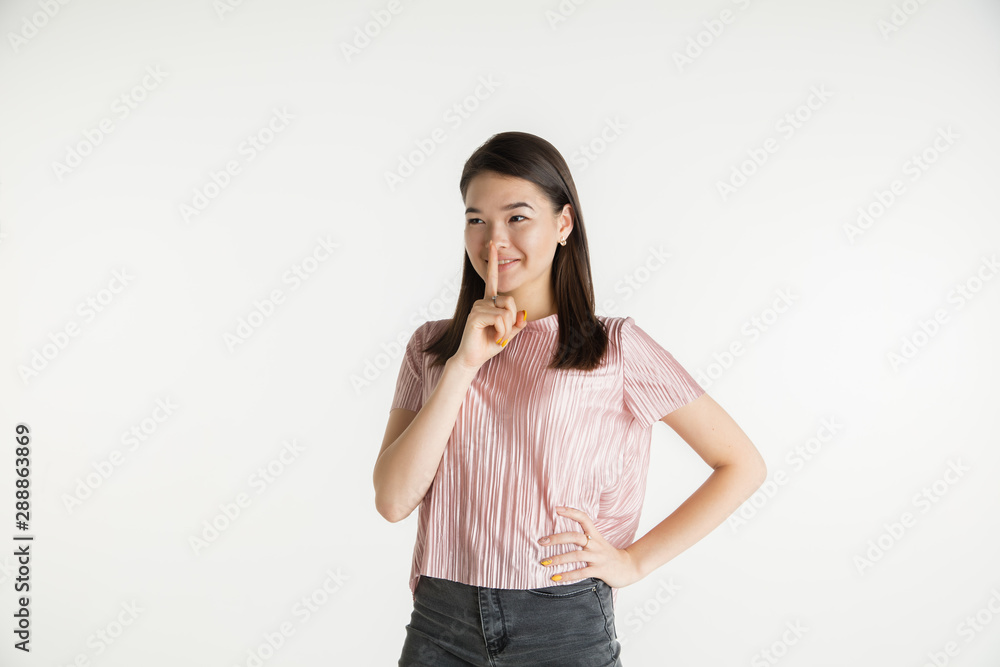 Beautiful female half-length portrait isolated on white studio background. Young emotional woman in casual clothes. Human emotions, facial expression concept. Whispering a secret, sales. Beautiful female half-length portrait isolated on white studio background. Young emotional woman in casual clothes. Human emotions, facial expression concept. Whispering a secret, sales.