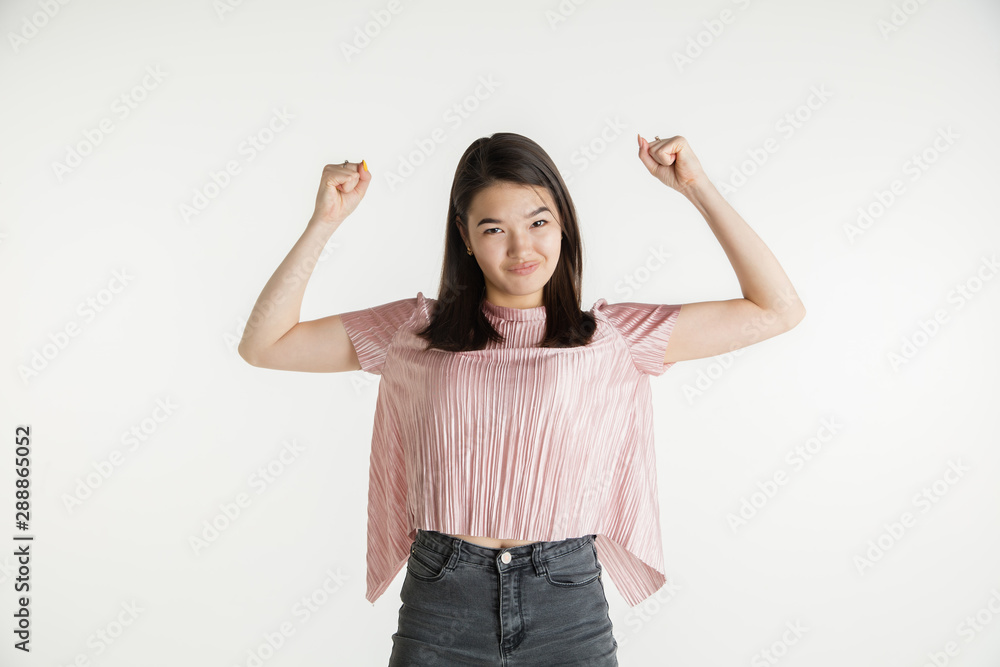 Beautiful female half-length portrait isolated on white studio background. Young emotional woman in casual clothes. Human emotions, facial expression concept. Celebrating like winner, looks happy. Beautiful female half-length portrait isolated on white studio background. Young emotional woman in casual clothes. Human emotions, facial expression concept. Celebrating like winner, looks happy.