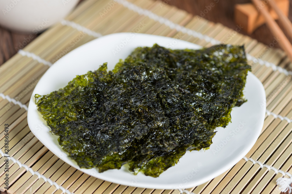 Nori sheet dried seaweed, Crispy seaweed on plate. Nori sheet dried seaweed, Crispy seaweed on plate.