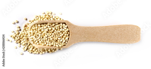 Organic quinoa seeds in wooden spoon isolated on white background, top view