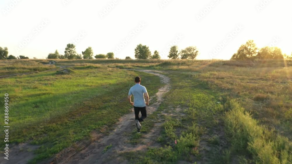 Aerial view of sport man running at countryside road. Healthy lifestyle concept video. Aerial view of sport man running at countryside road. Healthy lifestyle concept video.