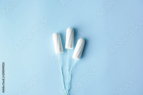 Menstrual tampons on a blue background. Menstruation cycle. Hygiene and protection. copy space