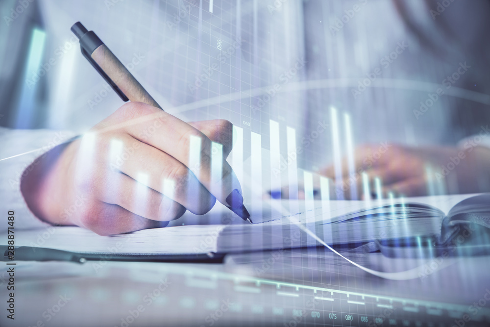 Multi exposure of woman's hands making notes with forex graph hologram. Concept stock market analysis. Multi exposure of woman's hands making notes with forex graph hologram. Concept stock market analysis.