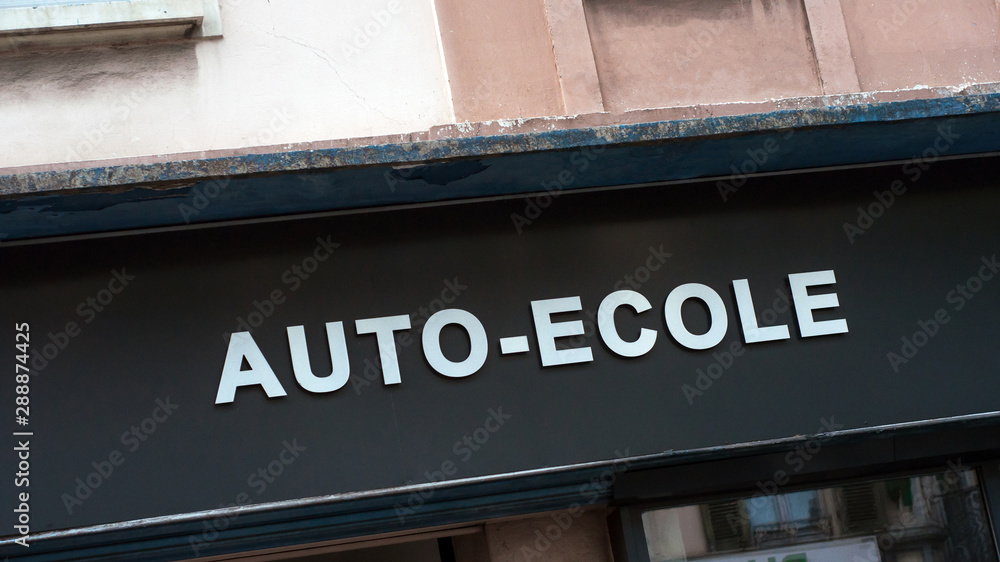 Fototapeta premium Closeup of driving school signage in french ( auto ecole) on building facade