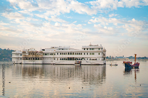 Morning view of lake Pichola and Taj Lake Palace with boats from Ambrai Ghat in Udaipur, Rajasthan, India