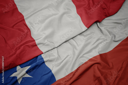 waving colorful flag of chile and national flag of peru.