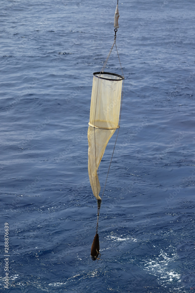 Plankton net on the blue water background. Science equipment for